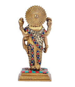 Brass Dhanvantari statue back view, radiant halo, jeweled blue-red robe, raised arms