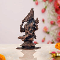 Copper Vishnu avatar statue side view, seated multi-armed with weapons and Lakshmi