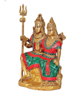 Brass Shiv Parvati idol with trident, blue bead accents and green patterned skirt