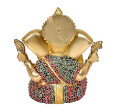 Golden brass Ganesha idol statue, back view with jeweled skirt and raised arms