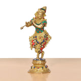 Krishna flute figurine standing on ornate base, gold finish with green and red accents