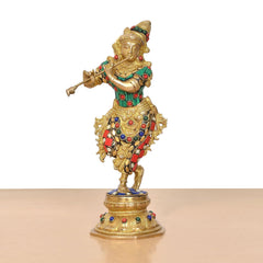 Krishna flute figurine standing on ornate base, gold finish with green and red accents
