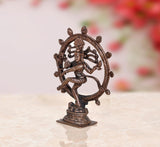 Copper Nataraja Shiva idol in side view, ornate circular halo, decorative base