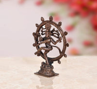 Copper Nataraja Shiva idol in side view, ornate circular halo, decorative base
