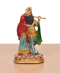 Resin Radha Krishna idol—side view showing crown, red drape, and green sash on Krishna