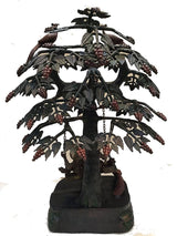 Brass Krishna and Radha swing on carved tree trunk, peacock top, hanging bead garlands
