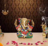 Brass Ganesha sculpture, seated with multicolor jeweled adornments and raised hands