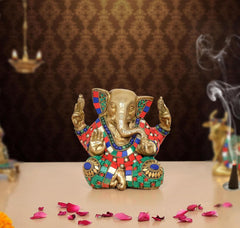 Brass Ganesha sculpture, seated with multicolor jeweled adornments and raised hands