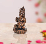 Copper Kuber statue, 2-inch side view, seated deity with blessing hand and lap ornaments