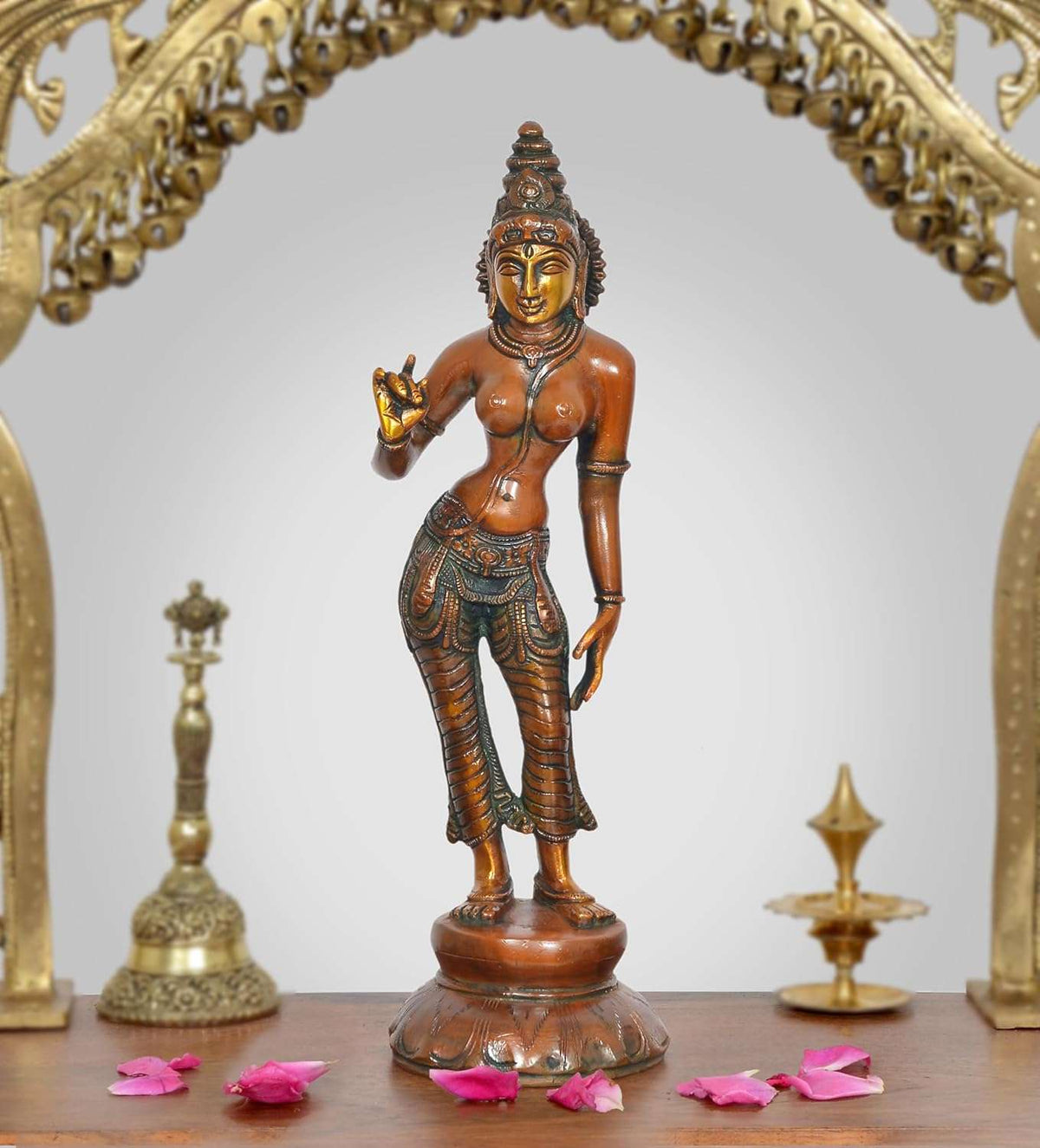 Brass goddess statue full view, standing on round base, detailed face and patterned outfit