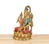 Side view of Lakshmi brass idol with teal and red robes, four-armed decorative pose