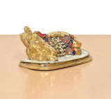 Brass Ganesha relaxing statue from side, gem-like multicolor motifs on brass body