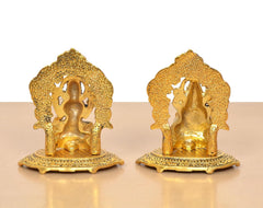 Golden metal Lakshmi and Ganesh statues back view, carved halo-like arch designs
