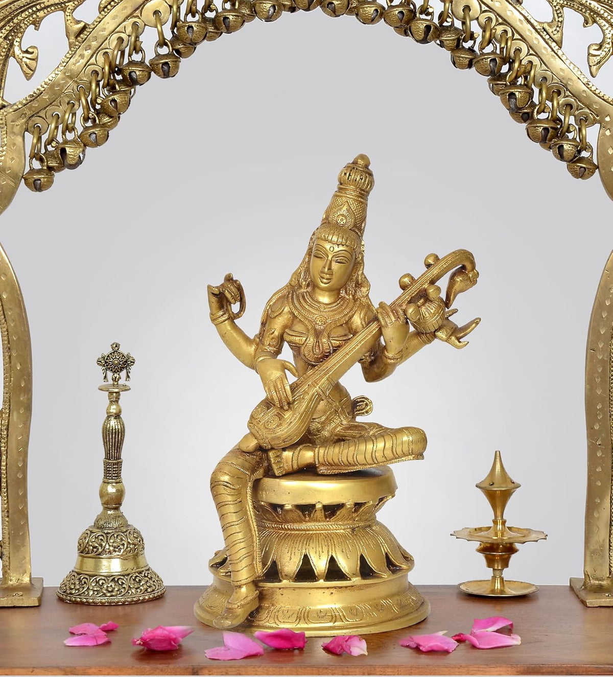 Handcrafted brass Maa Saraswati idol, seated holding a veena on an ornate base