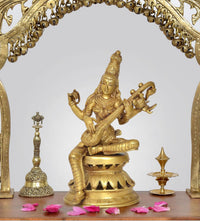 Handcrafted brass Maa Saraswati idol, seated holding a veena on an ornate base