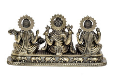 Rear view brass Ganesha Lakshmi Saraswati showpiece with crown-like details