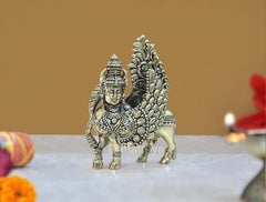 Brass Kamadhenu cow figurine with wings and raised deity arm, ornate detailing