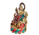 Brass Dhan Lakshmi idol, side view with raised hand and jeweled teal-red dress