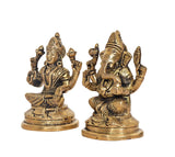 Brass Lakshmi and Ganesha idols, side angle view with crowns, faces, and raised arms.