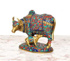 Side view Kamdhenu cow statue with calf, multicolor patterned saddle and legs