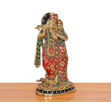 Three-quarter view of Radha Krishna brass statue in red, green, and blue jeweled attire