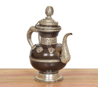 AONA brass teapot with ornate lid cap, curved handles, dark brown belly with embossing