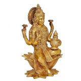 Brass Lakshmi idol statue in profile, holding small pot, ornate headdress and jewelry