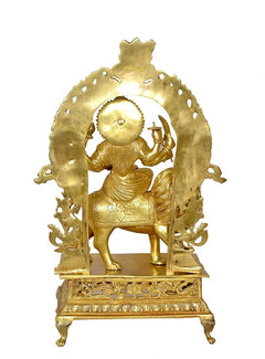 Brass Durga statue idol close-up showing halo arch, lion, and raised hand