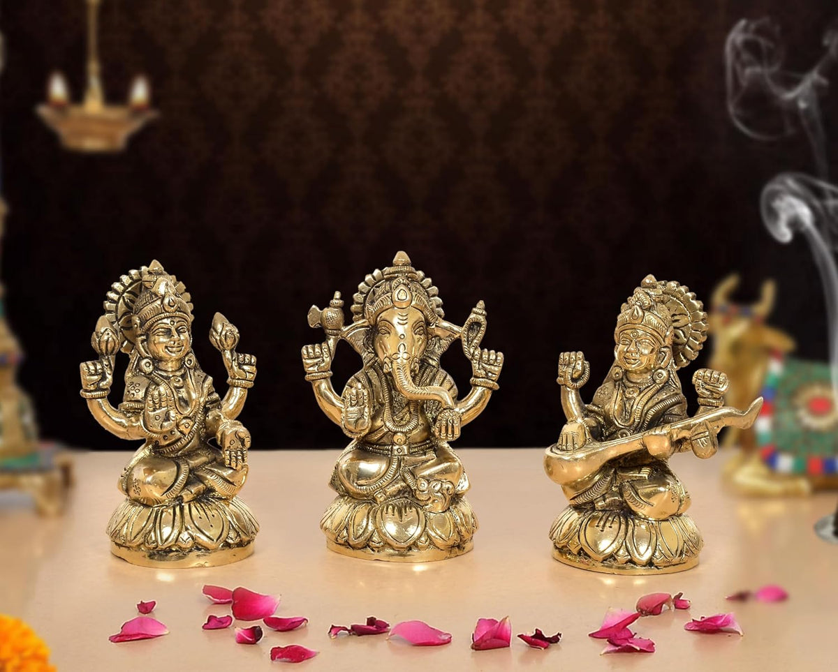 Brass Lakshmi Ganesha Saraswati idol set, three golden figures with raised hands