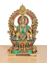 Lakshmi goddess brass idol with ornate halo, teal outfit and colorful beaded trim