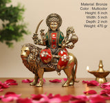 Superfine brass goddess murti on lion, 6 inch height, multicolor accents