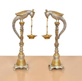 Front view of brass parrot diya lamp stands, set of 2, curved wings and hanging lamps