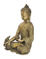 Brass meditating Buddha statue, side view with closed eyes and Dhyan mudra hands