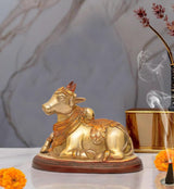Brass Nandi bull statue, seated with ornate headgear and jewelry, for pooja decor