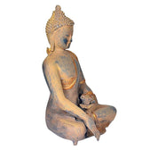 Brass Buddha statue side view, seated meditating with one hand raised, gold details