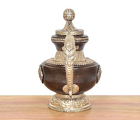 Brass decorative teapot, tall lid finial and central sculpted figure on front body