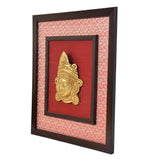 Brass Maa Durga face idol wall hanging, gold deity head relief inside dark square frame