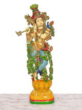 Krishna playing flute figurine with ornate crown and jewelry, multicolored resin