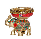 Brass elephant statue front view with red urli bowl and ornate multicolor details