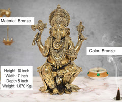 Bronze-colored Lord Ganesha idol, seated with patterned dhoti and jeweled ornaments