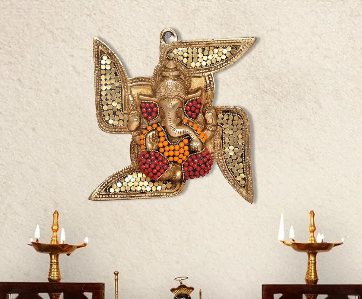 Brass Ganesha swastik wall hanging with red/orange beadwork and hanging loop