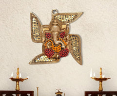 Brass Ganesha swastik wall hanging with red/orange beadwork and hanging loop