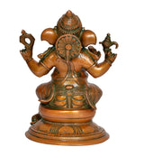 Brass Ganesha idol rear view, ornate circular halo and seated trunked face