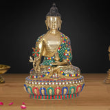 Brass meditating Buddha statue with jeweled cloak and raised hand, circular base