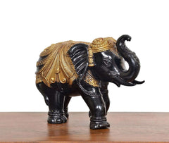 Black and gold elephant figurine, rear 3/4 view, gold patterned back and raised tail