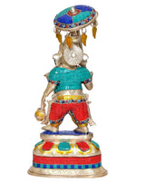 Back view of brass Ganpati showpiece with umbrella canopy, teal and red clothing