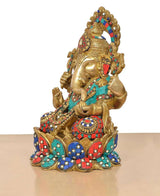 Ganesha brass idol side view with ornate trunk and teal-red-blue jeweled details
