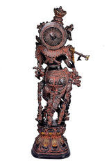 Back view brass Krishna idol with radiant halo disc and multiple arms on ornate base