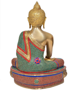 Back view of brass meditating Buddha statue, teal red patterned robe, ornate seated base