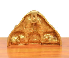 Back view of brass Gaja Lakshmi idol, curved dome with stamped center marking